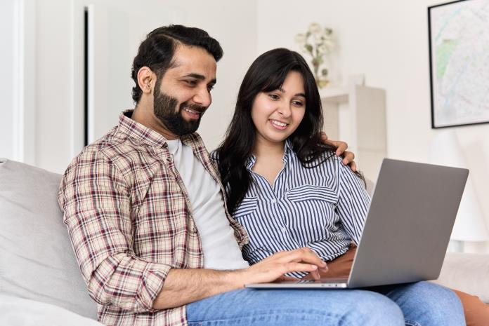 Smiling Couple buying term insurance cover online