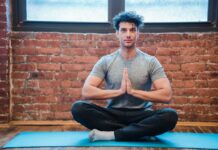 Young man doing pranayama yoga and meditation