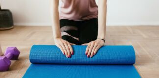 Exercise helps mitigate fatigue post breast cancer treatment Woman with yoga mat | Concept for exercise mitigates fatigue post breast cancer treatment