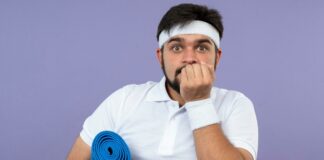 Man with yoga mat worried about exercise