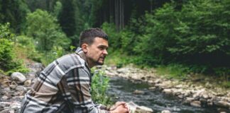 What It Really Means to Seek Wisdom (And Why Most of Us Avoid It) Man sitting alone in the woods watching the stream | wisdom seeker