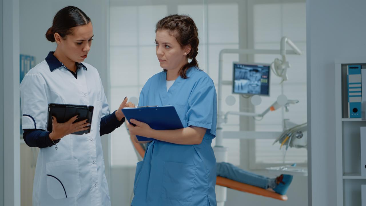 Nurse discussing a patient case with a doctor in a hospital