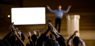 When Role Models Disappoint: How to Avoid the Pitfalls of Hero Worship Why Role models Disappoint | Blurred leader on stage enjoying adulation of the audience